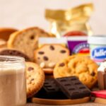A high-quality, detailed image of various food products containing soy lecithin. In the foreground, a close-up of a jar or package of soy lecithin, showcasing its texture and consistency. In the middle ground, an assortment of common food items like bread, cookies, chocolate, and ice cream, all with soy lecithin listed as an ingredient. In the background, a neutral, clean backdrop, with soft, warm lighting from the side, emphasizing the natural tones and textures of the products. The overall mood is informative and educational, highlighting the widespread use of soy lecithin in a variety of food items.