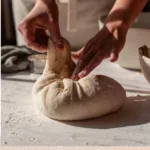Freshly baked Dutch Oven Sourdough Bread on a wooden table
