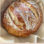 Freshly baked overnight sourdough bread on a wooden table