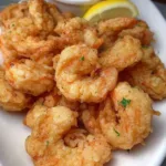 Plate of crispy Southern fried shrimp with a side of dipping sauce