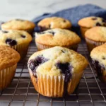 Freshly baked gluten-free blueberry muffins on a cooling rack