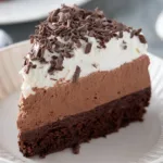 Gluten-free chocolate mousse cake with rich chocolate topping and garnishes