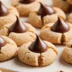 Delicious gluten-free Peanut Butter Blossoms with chocolate kisses on top