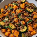 Ground beef zucchini sweet potato skillet cooked and served in a pan