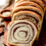 Loaf of homemade cinnamon swirl bread with a golden crust and cinnamon filling