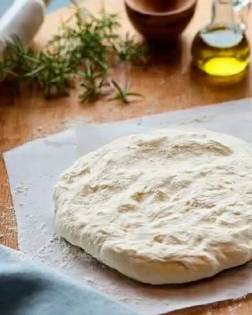 Homemade pizza dough ready for baking and topping with ingredients.