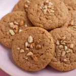A plate of freshly baked peanut butter cookies, golden and delicious.