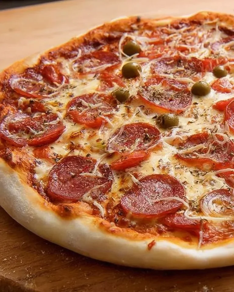 Homemade thin-crust pizza dough ready for topping and baking